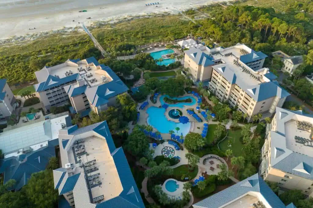 Aerial view of pool, building, beach