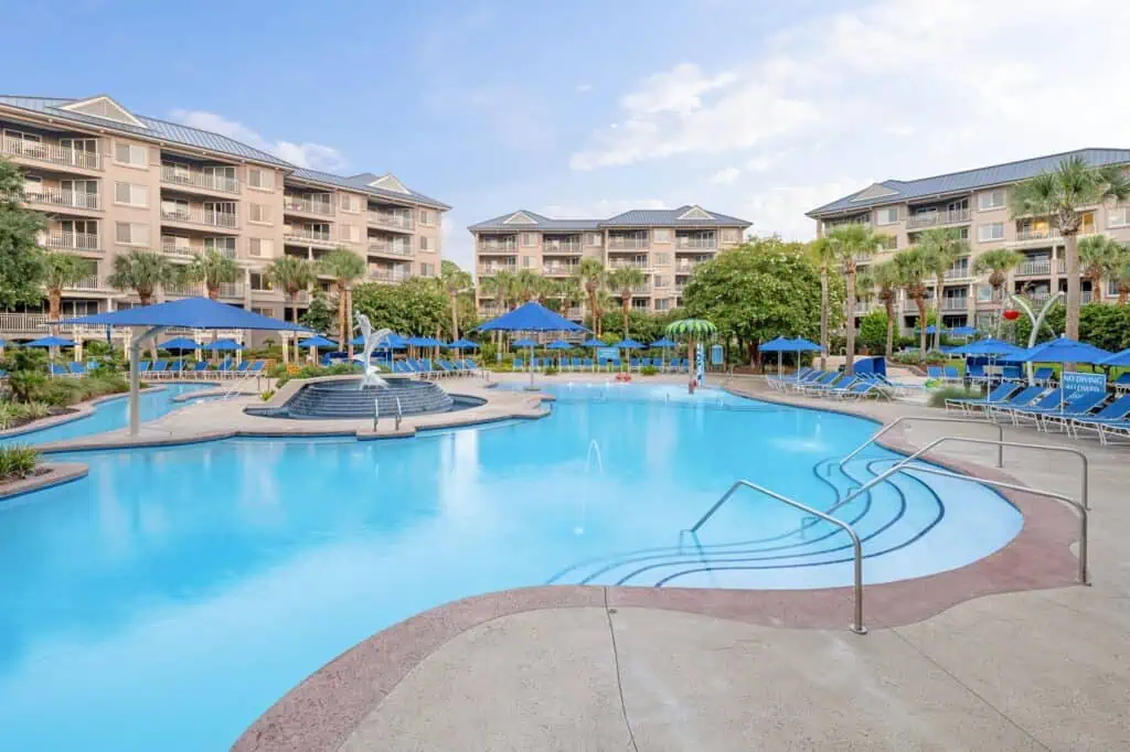 Resort pool with loungers, umbrellas
