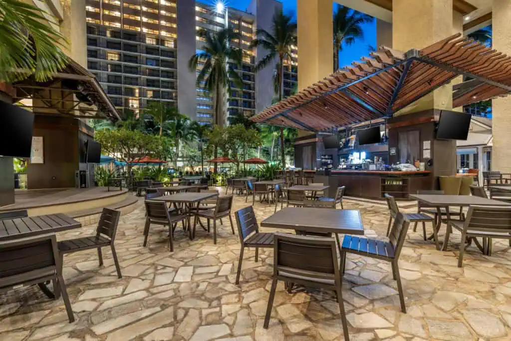Open-air bar and patio tables at Hilton Hawaiian Village
