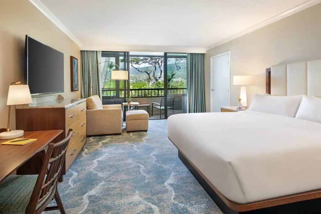King bed with seating area and balcony