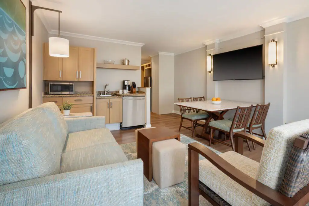 Sofa, chair, dining table, wet bar, TV on wall