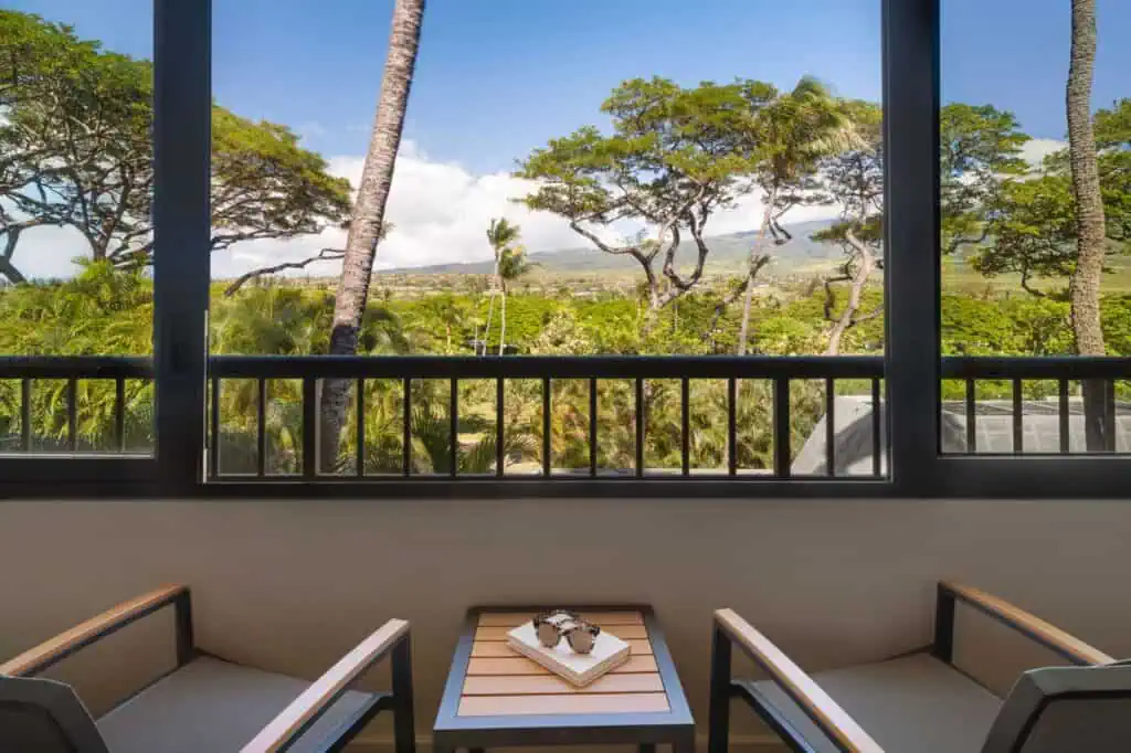Balcony with chairs and view of island trees