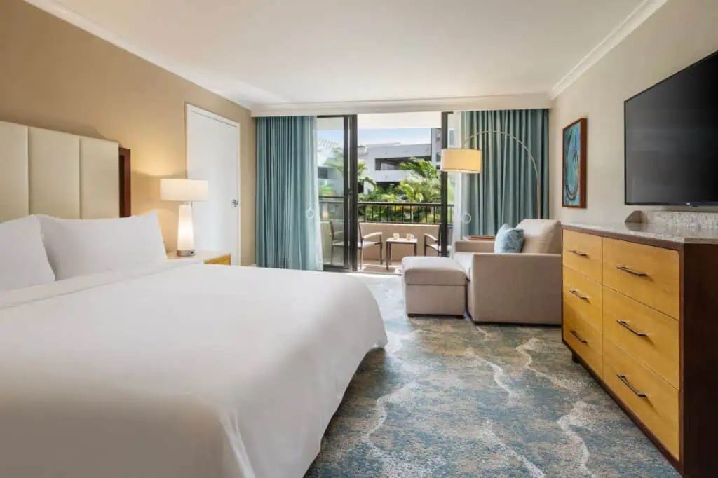 King bed, chair, TV, furnished balcony