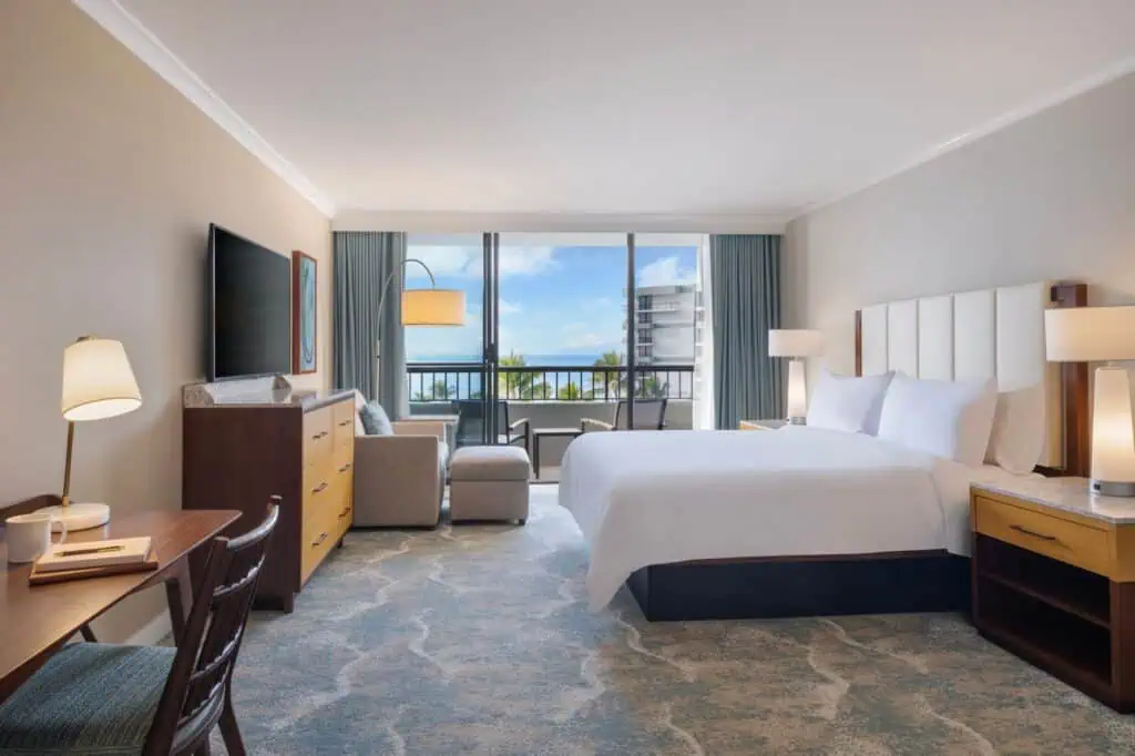 King bed, chair, desk, TV, furnished balcony