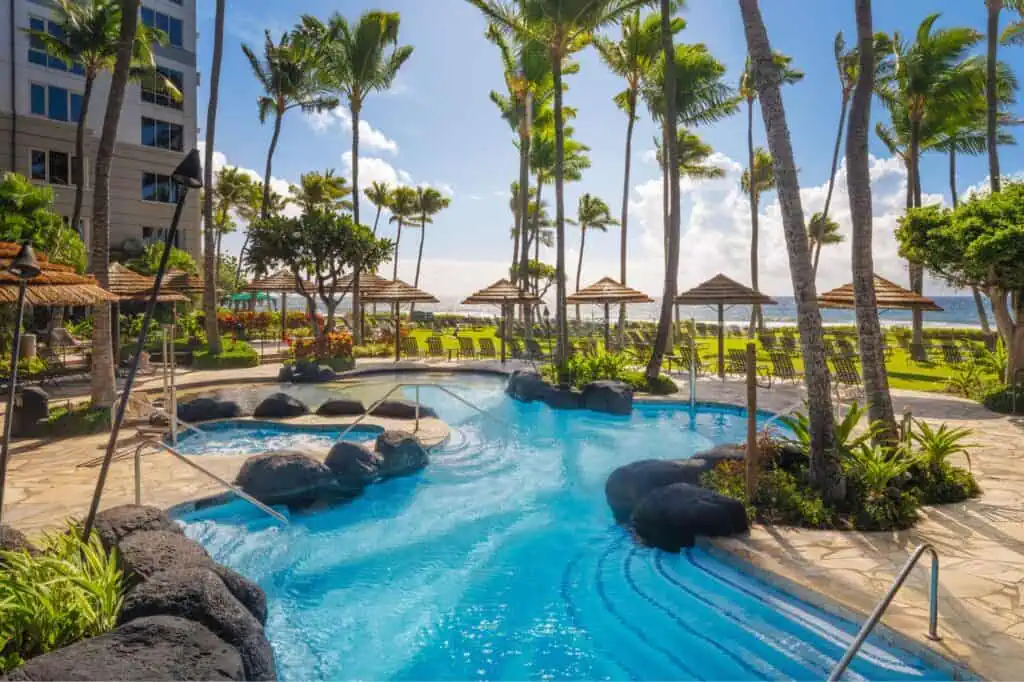 Resort pool, whirlpool, loungers, view of beach