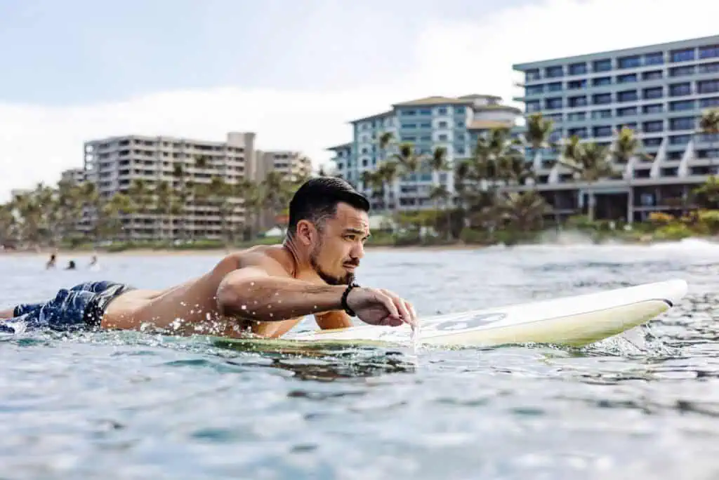Man in ocean on surfboard in Maui, Hawaii