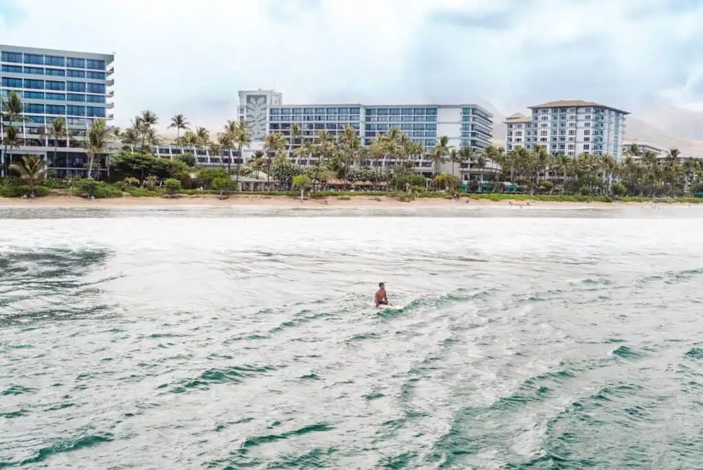 Exterior with beach and man on surfboard