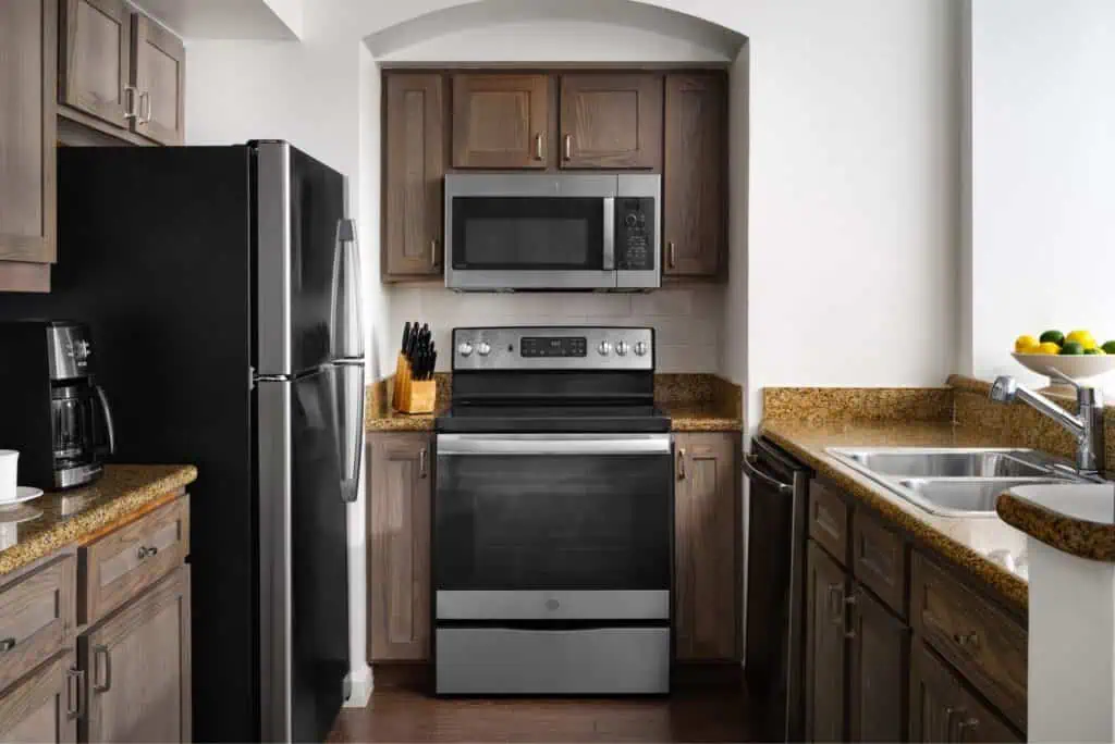 Kitchen with fridge, microwave, oven, coffee maker