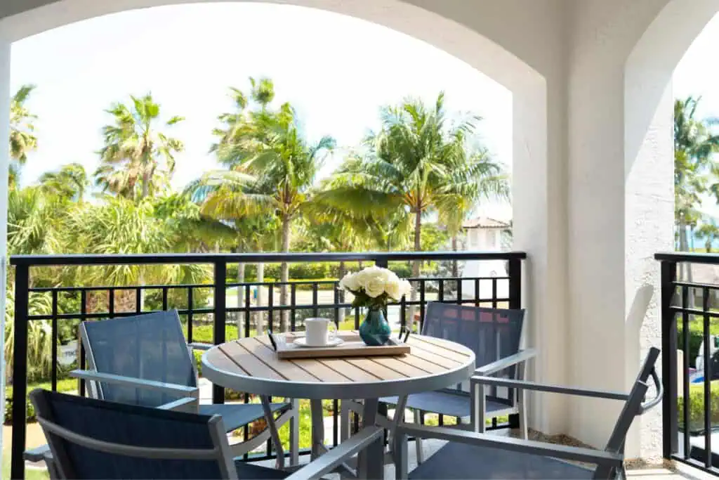 Balcony with table and chairs overlooking grounds