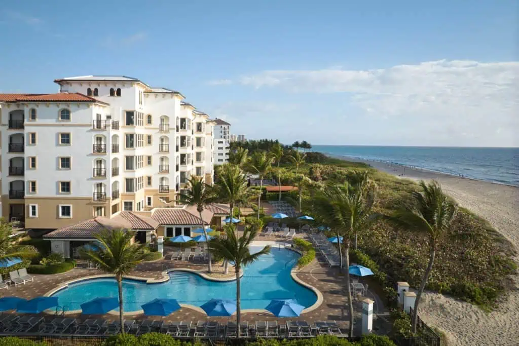 Pool near building, beach, palm trees