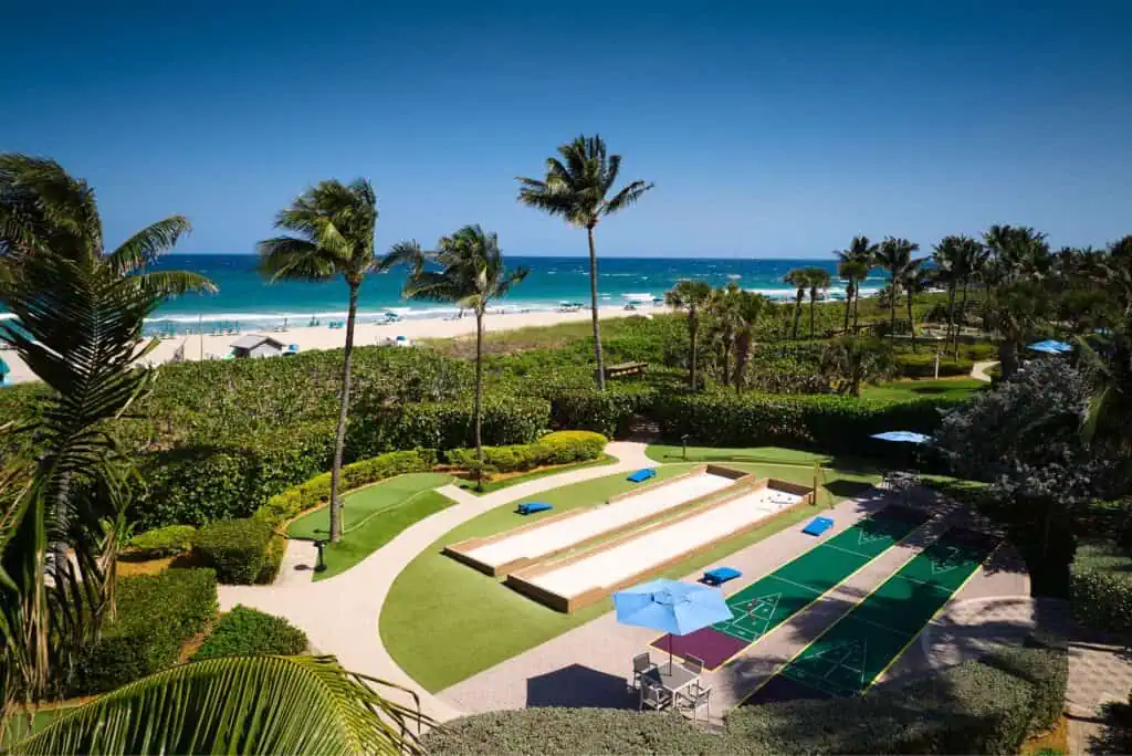 Lawn with games overlooking beach, ocean