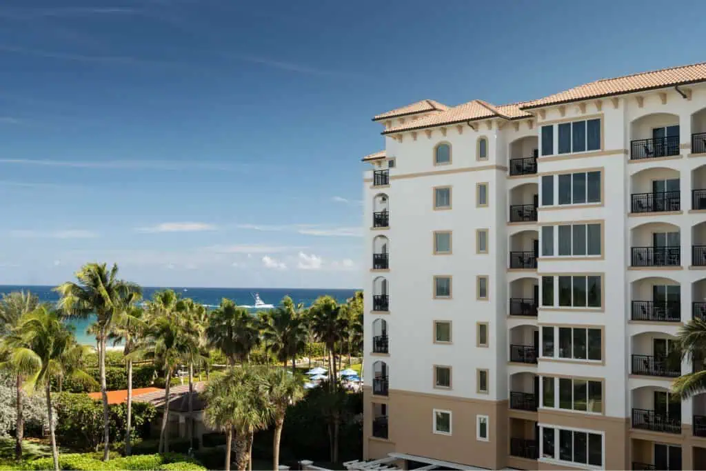 Building exterior with view of ocean and boat